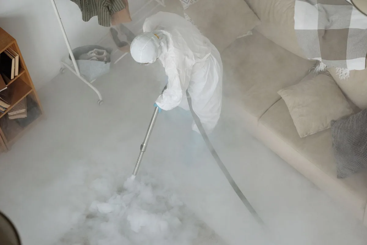 Biohazard cleanup technician in protective equipment, Thayer, MO